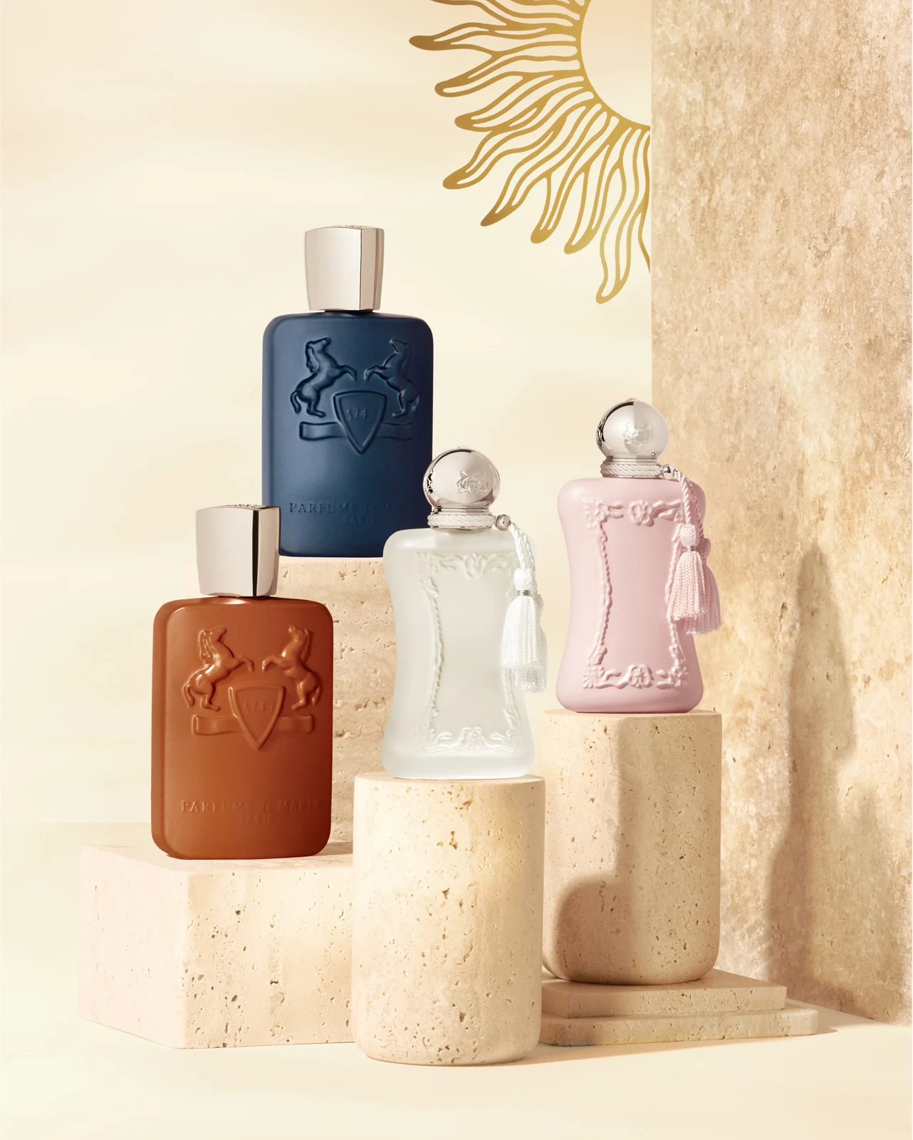 Parfums de Marly fragrance bottles displayed on sunlit ivory plinths