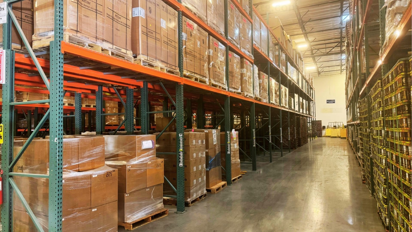 Warehouse aisle with shelves of packaged inventory