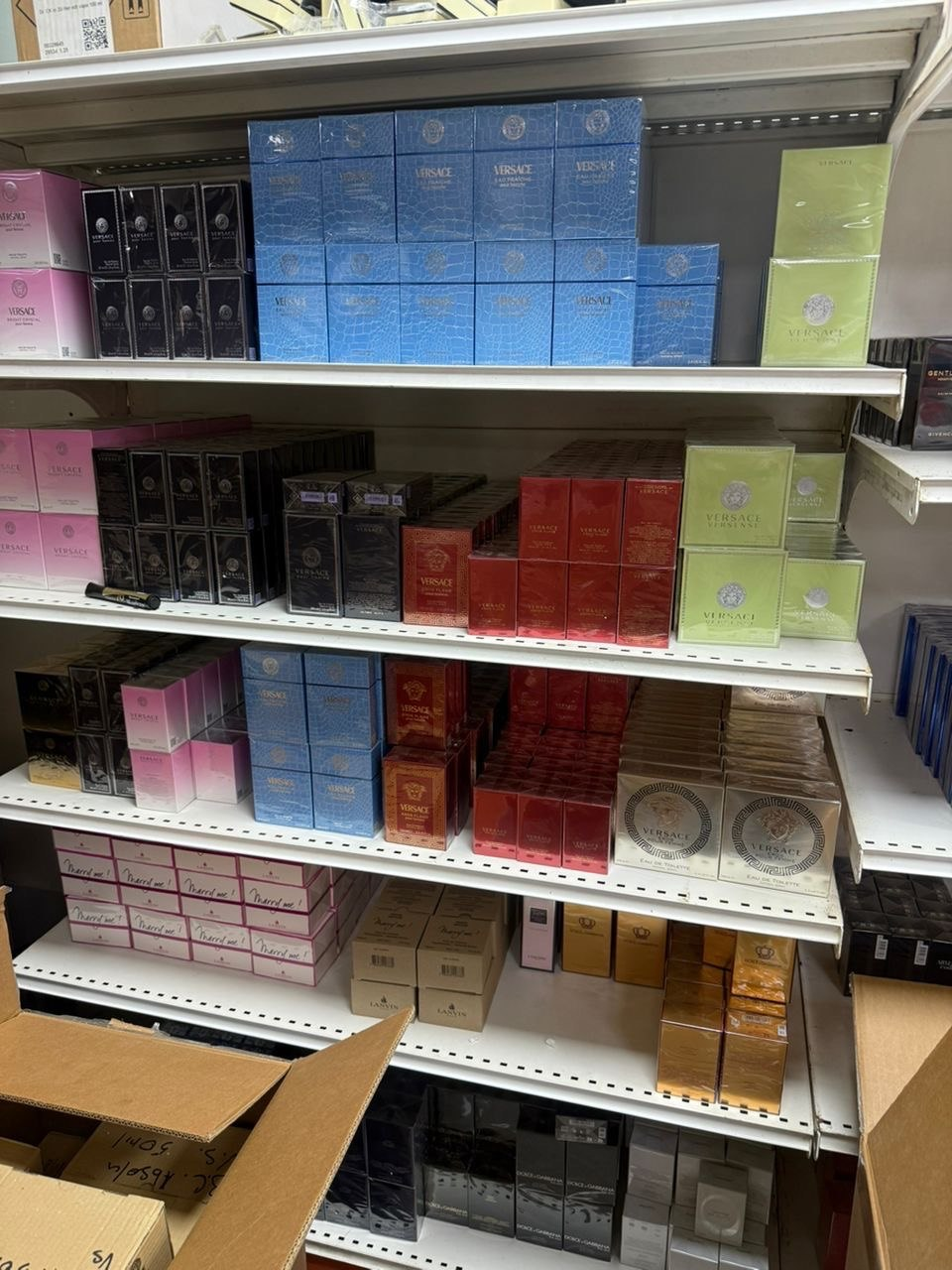 Shelves displaying packaged perfume collections